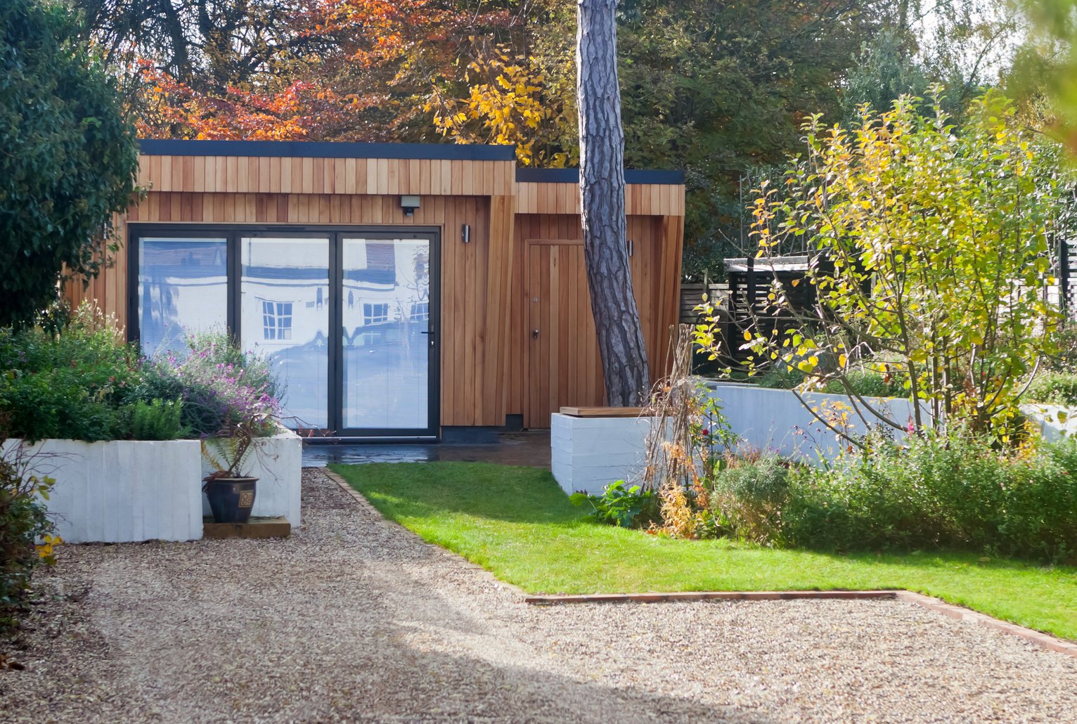 Bespoke Western Red Cedar Clad Home Garden Office with Bifold Doors, Slate Terrace, Barbecue and Firepit with Raised Flower Beds